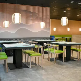 a dining area with green chairs