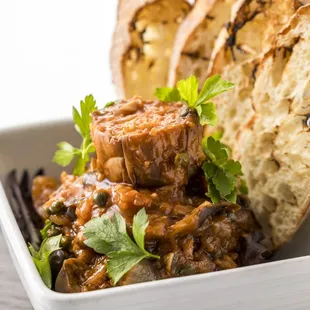 Eggplant Caponata 
シチリア伝統の味 茄子と野菜のトマト煮込み 
Chilled eggplant, capers, olives, vegetables with tomato and red wine vinaigrette