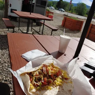 Bacon breakfast burrito with pico de gallo relish.