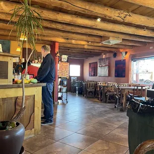 a man standing at a counter in a restaurant