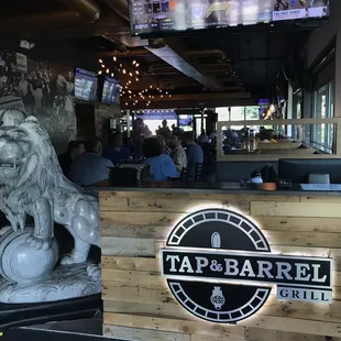 a lion statue in front of a bar