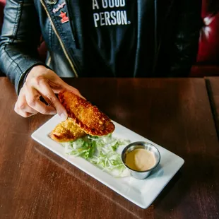 a person sitting at a table with a plate of food