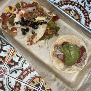 Veggie taco(eaten) / pork carnitas taco