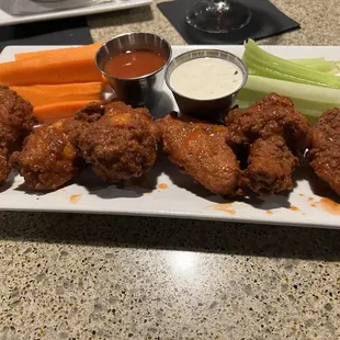 Buffalo wings tossed and with sauce on the side