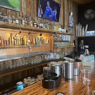 a bar with beer taps and a television in the background