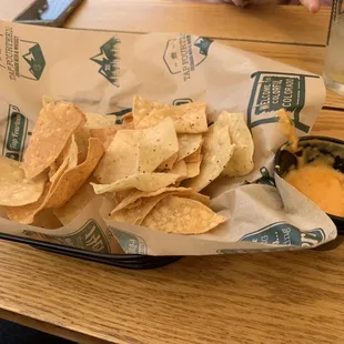 Stale chips and tiny queso that&apos;s not very good