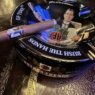 a cigar and ashtray