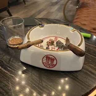 a ashtray and a glass of water