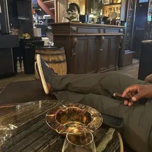 Small bar area, ashtray, delicious on tap cocktail and sample of available cigars