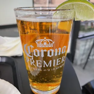 a glass of beer and a slice of lime