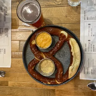 a plate of pretzels and beer on a table