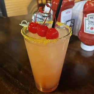 a cocktail with cherry garnish