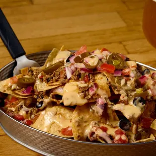 a bowl of nachos and a glass of beer