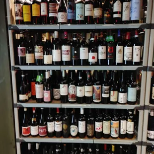 a shelf full of wine bottles