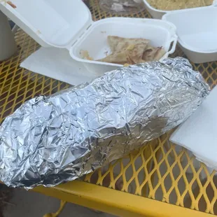 a sandwich wrapped in aluminum foil