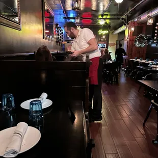 a man preparing food in a restaurant