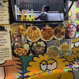 a food truck with menus on the side