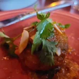 Albondigas: Three lamb meatballs, tomato sauce, sliced  almonds and cilantro (one of 3)