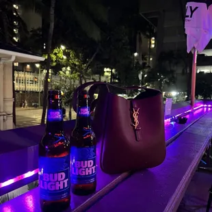 two bottles of beer on a bar