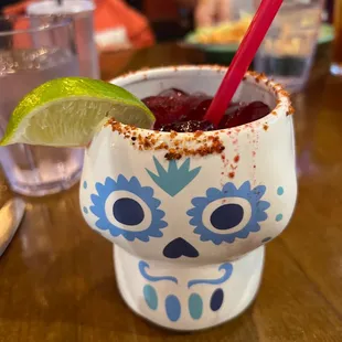 a margarita in a sugar skull cup