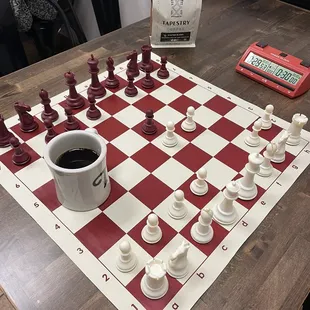a cup of coffee on a chess board