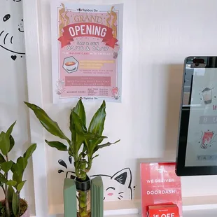 a desk with a computer and a potted plant