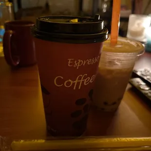 My mint milk tea they handed me in a coffee cup because they ran out of cups... the drink behind it is my lychee milk tea that tasted weird.