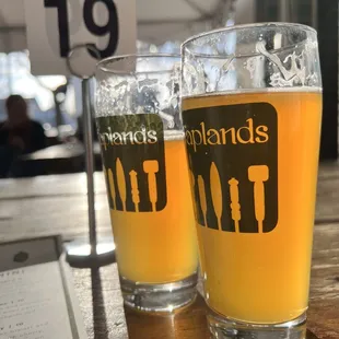 two glasses of beer on a table