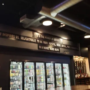 Large selection of beer in coolers and an even larger selection on tap