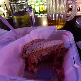 Ruben sandwich and small pitcher if beer.