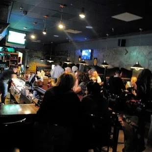 a group of people sitting at a bar