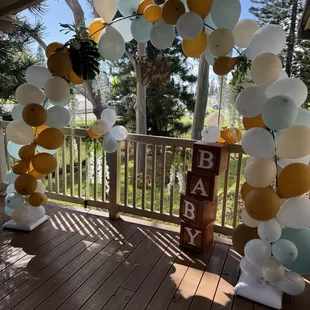 The end of the patio with a balloon arch.