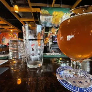 a glass of beer on a bar