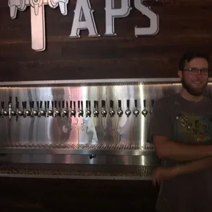 a man standing in front of a tap