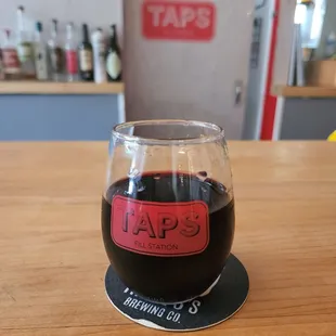 a glass of wine on a coaster