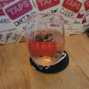 a glass of beer on a coaster