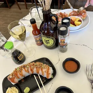 Not so spicy hamachi roll (minus Serrano peppers, Sriracha on the side) for me, lox for him