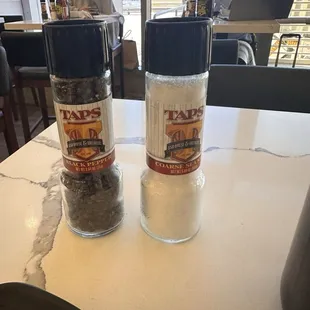 Salt and pepper with taps branding.