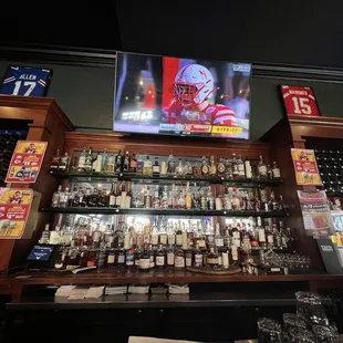 a football player on the screen above the bar