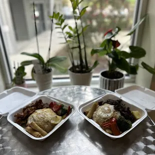 two containers of food on a table