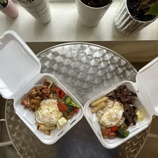 two takeout containers of food on a table