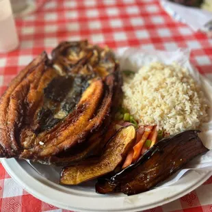 Bangus with garlic fried rice, slices of tomatoes and eggplant
