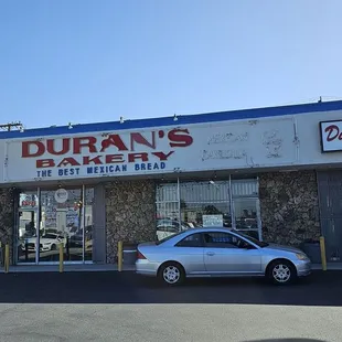 The entrance is on the left side of the building under the D in Duran's.
