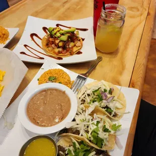 Tacos beef and pork, rice green chili, Beans and ceviche tostada  even that was so good, my adult drink and water.