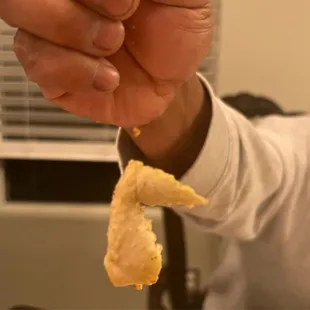 a person holding a piece of food