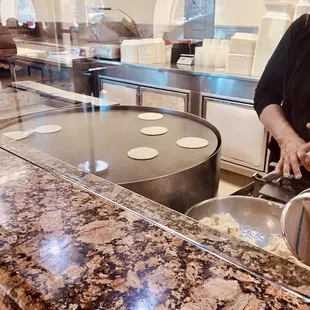 a man making tortillas