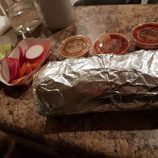 a taco wrapped in aluminum foil