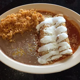 Enchilada + Tamale with beans and rice.