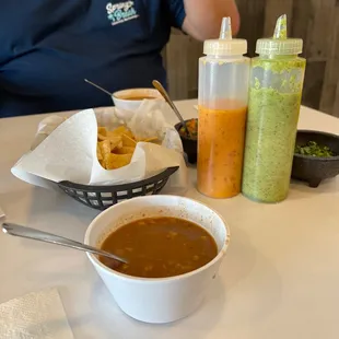 a man sitting at a table with a bowl of soup