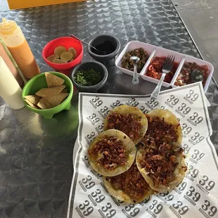 Pastor tacos with toppings/ chips